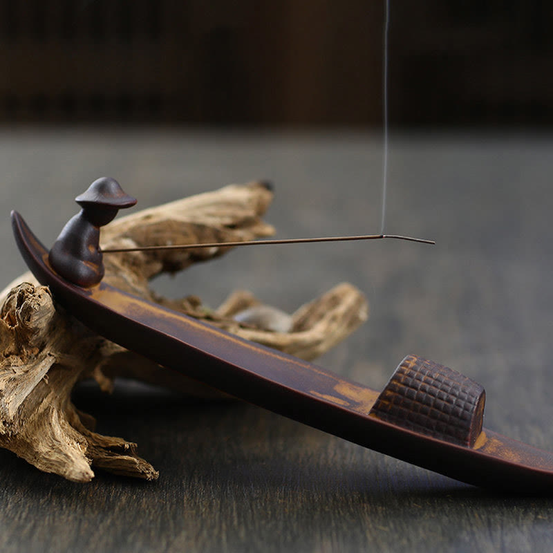 Wooden incense burner with smoke on a dark background