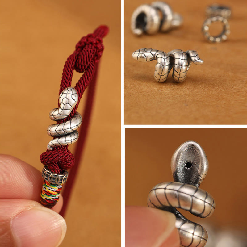 Silver snake-shaped bead on a red cord with close-up shots on a brown background