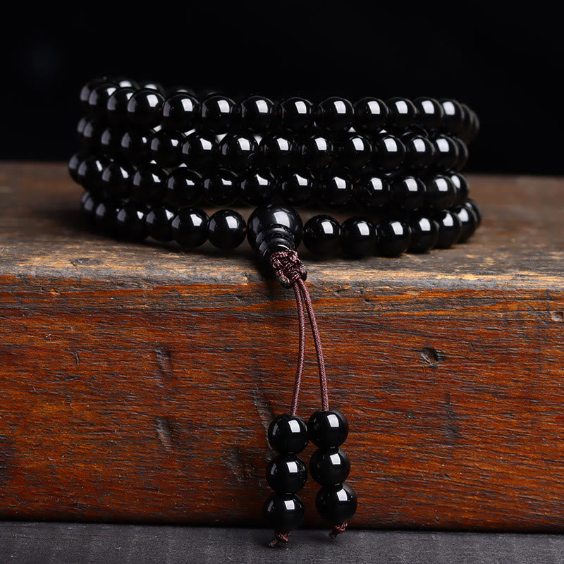 Black beaded bracelet on a wooden surface