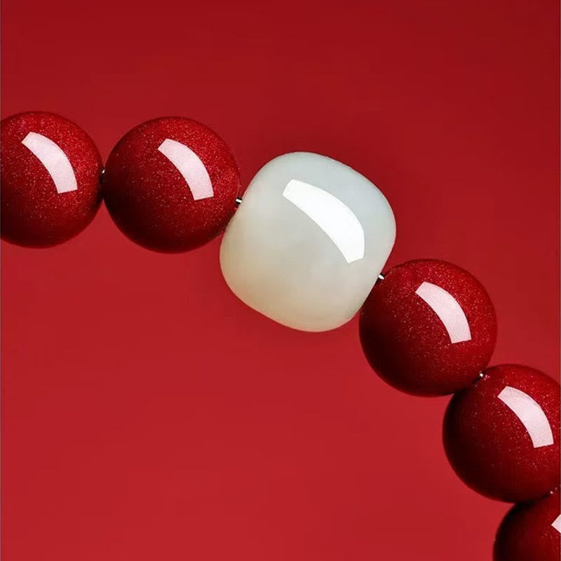 Beads with a red and white stone on a red background