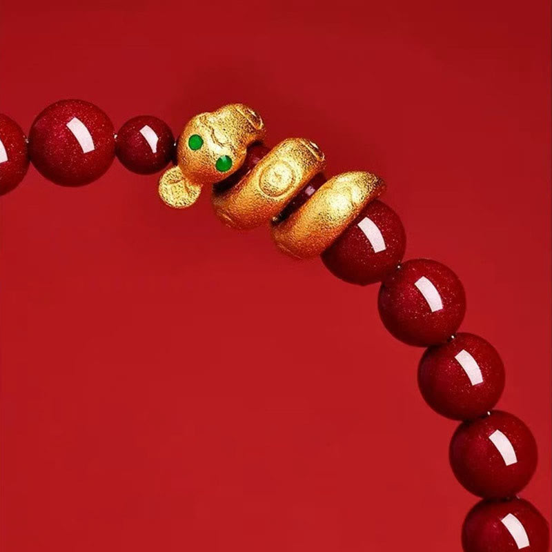 Bracelet with red beads and gold monkey charm on a red background