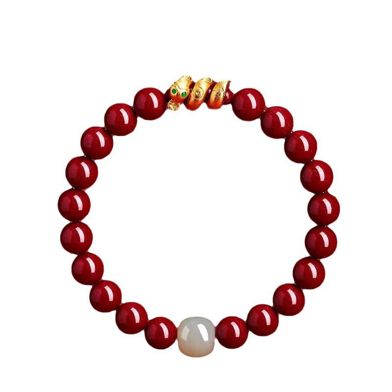 Red beaded bracelet with a gold clasp on a white background