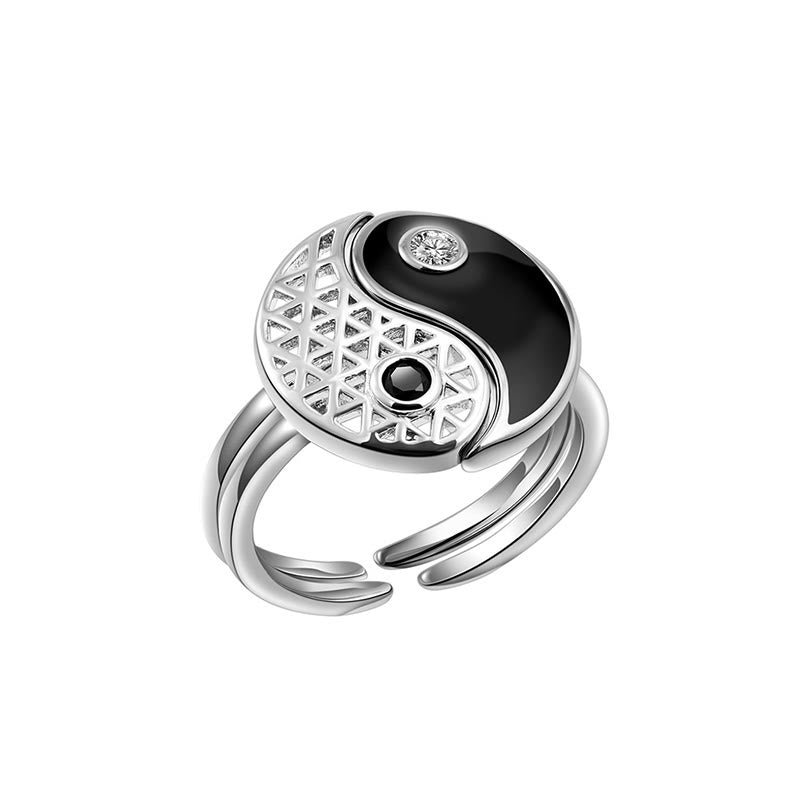 Silver ring with black and white design on a white background