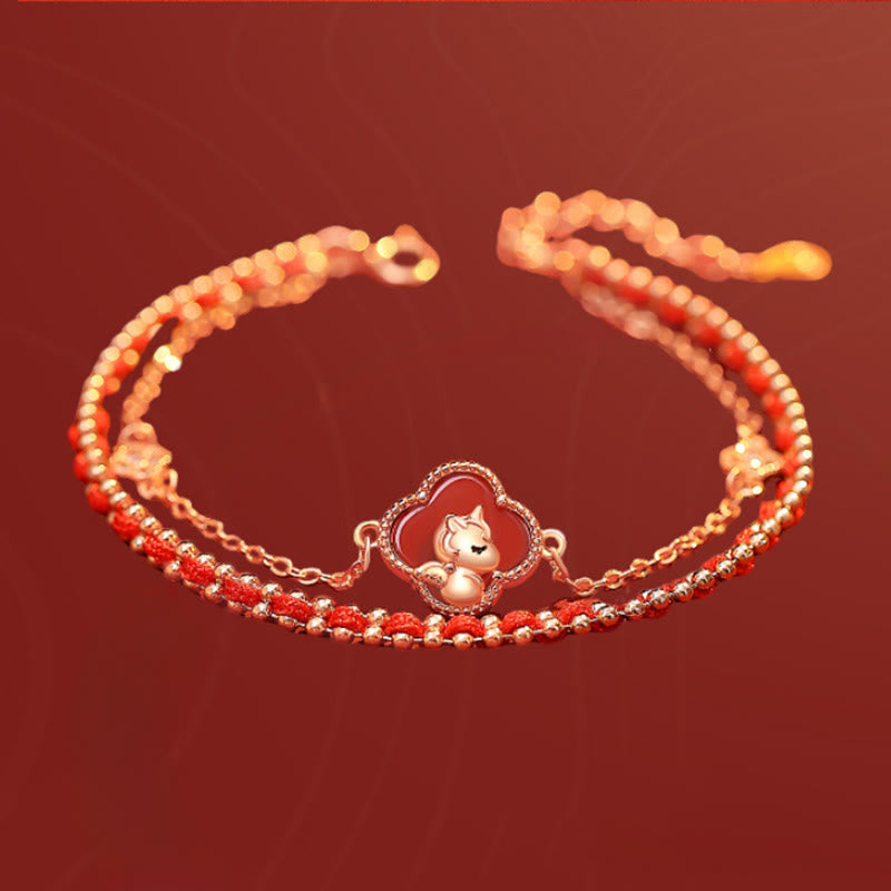 Bracelet with a small animal charm on a red background