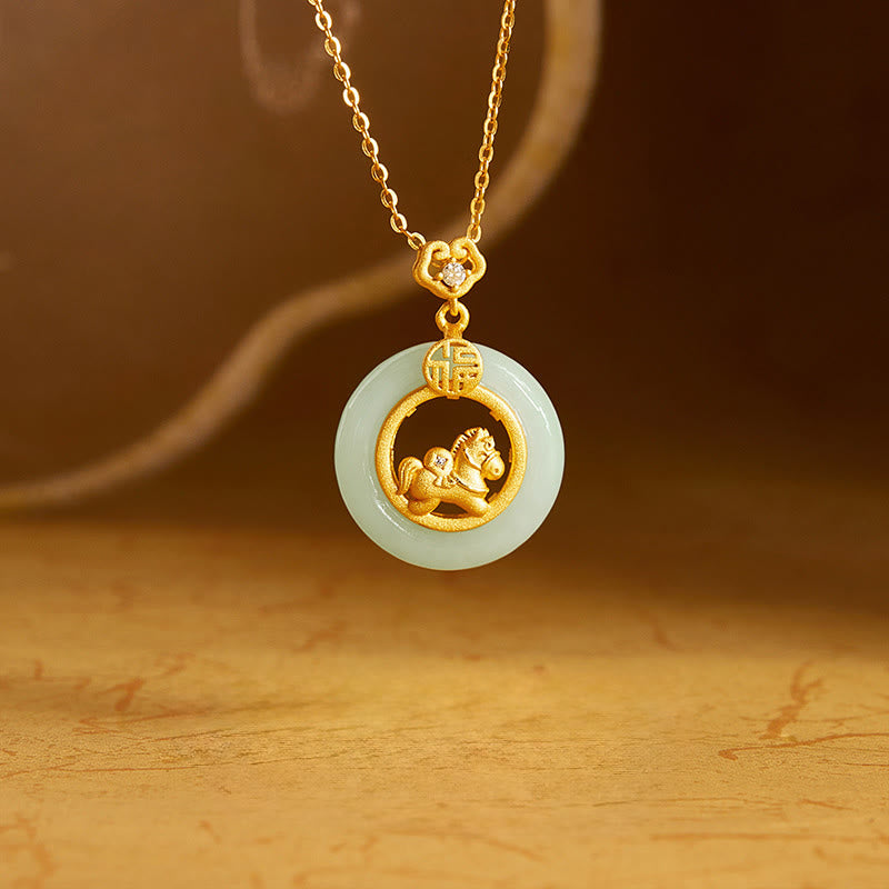 Gold necklace with a jade pendant featuring a horse design on a wooden surface.