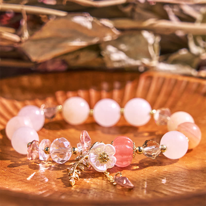 Beaded bracelet with floral elements on a wooden surface
