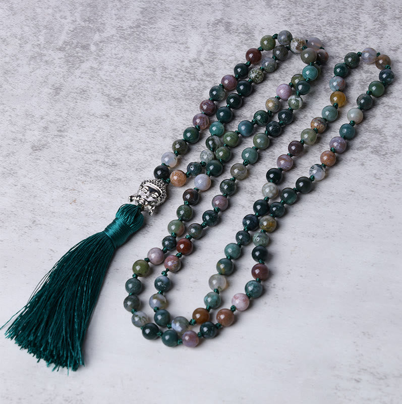 Multicolored beaded necklace with a tassel on a gray surface