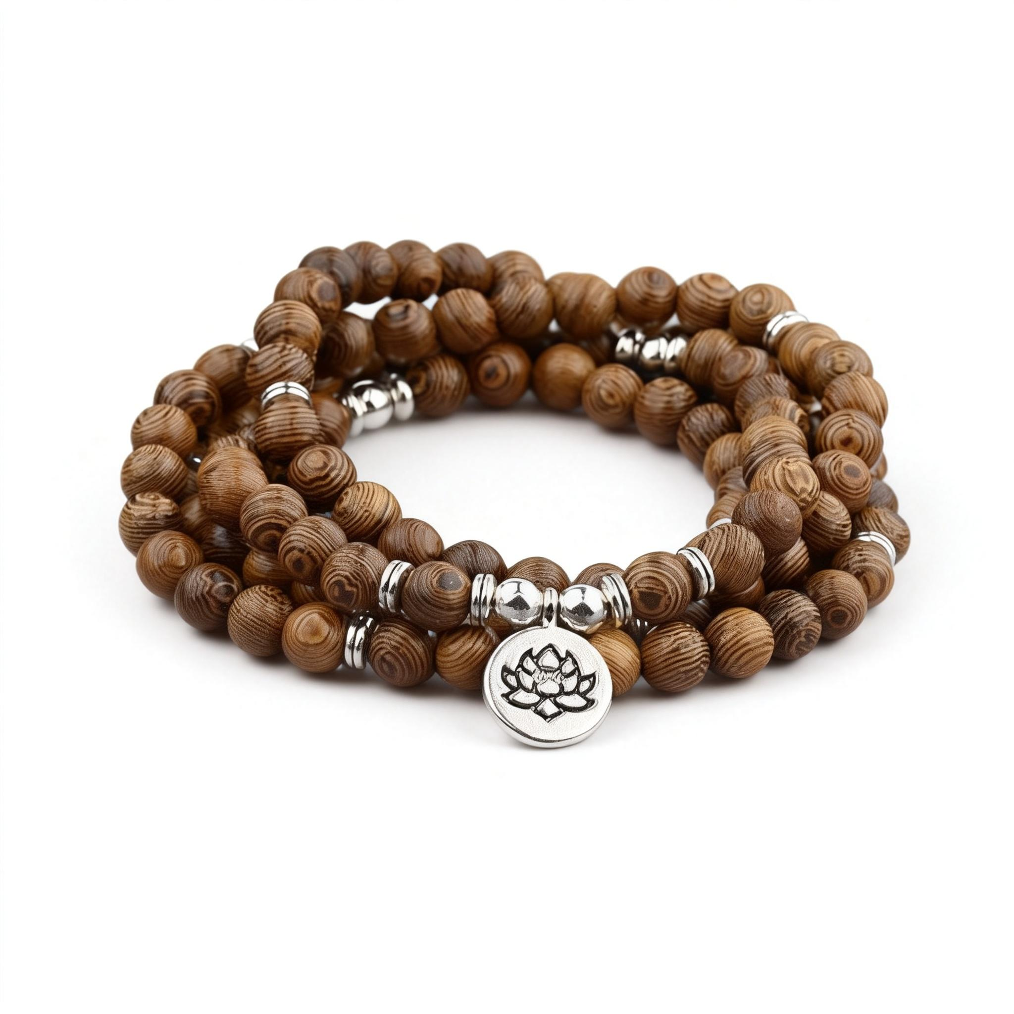 Wooden beaded bracelet with silver lotus charm on a white background