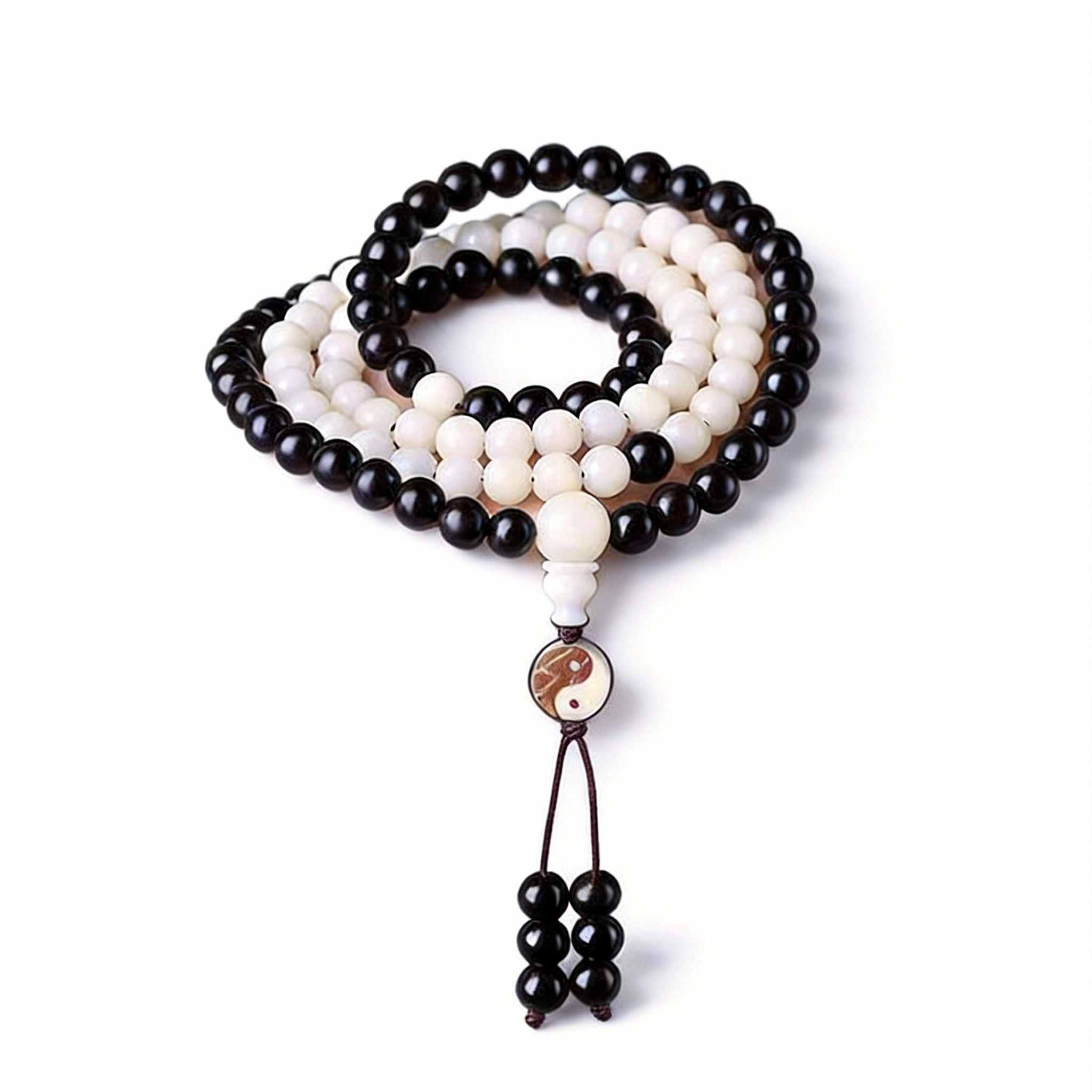 Black and white beaded necklace with a yin yang pendant on a white background