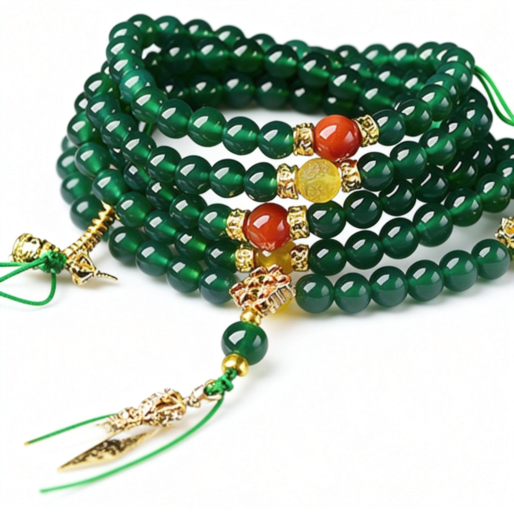 Green beaded bracelet with gold and red accents on a white background