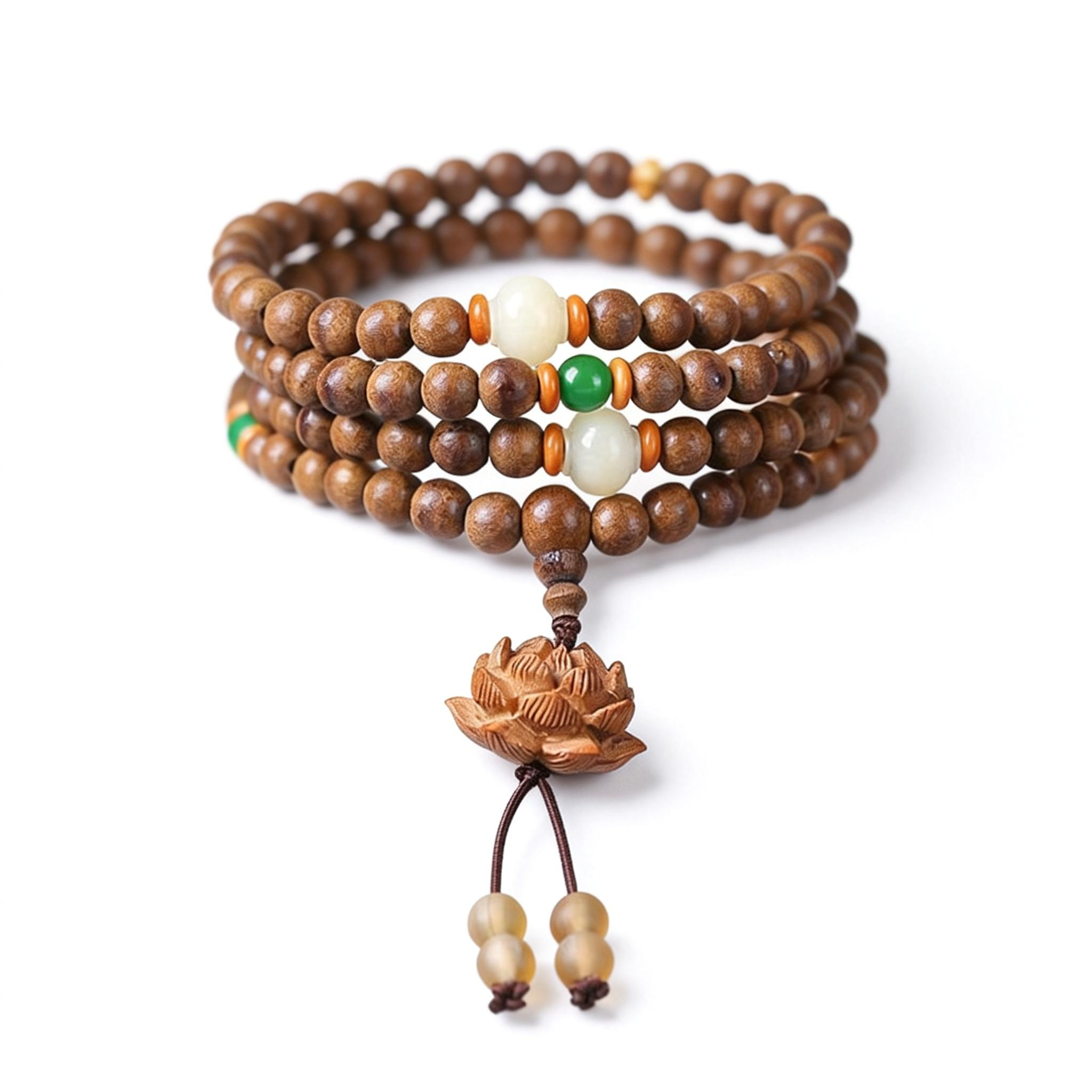 Wooden beaded bracelet with a lotus flower charm on a white background