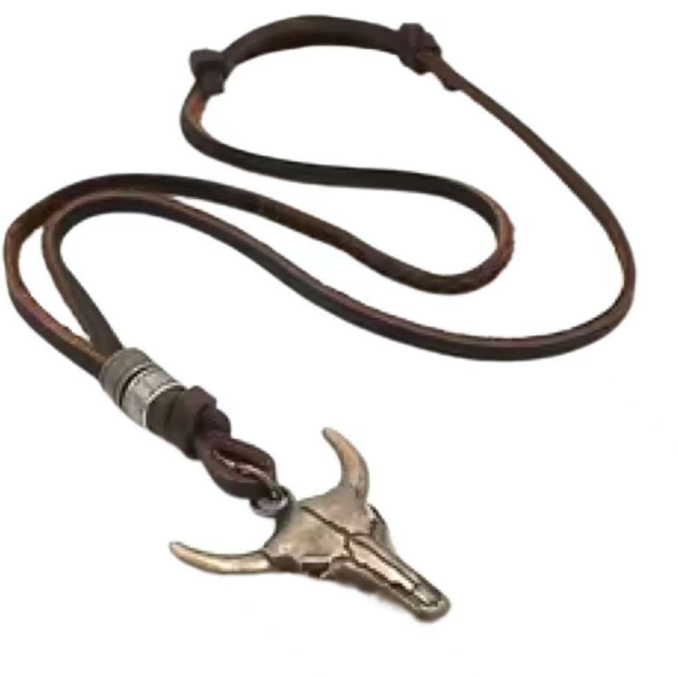 Necklace with a silver bull head pendant on a brown leather cord against a white background