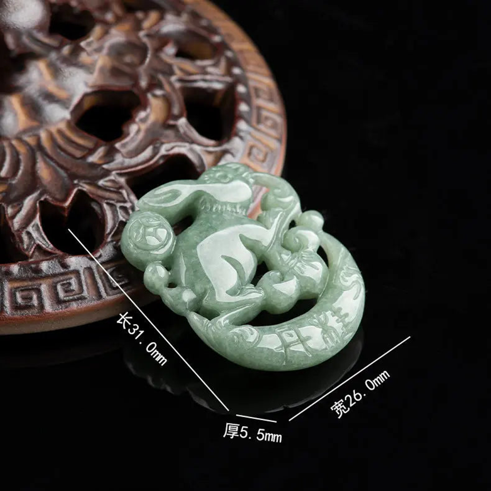 Green jade pendant with measurements on a dark background