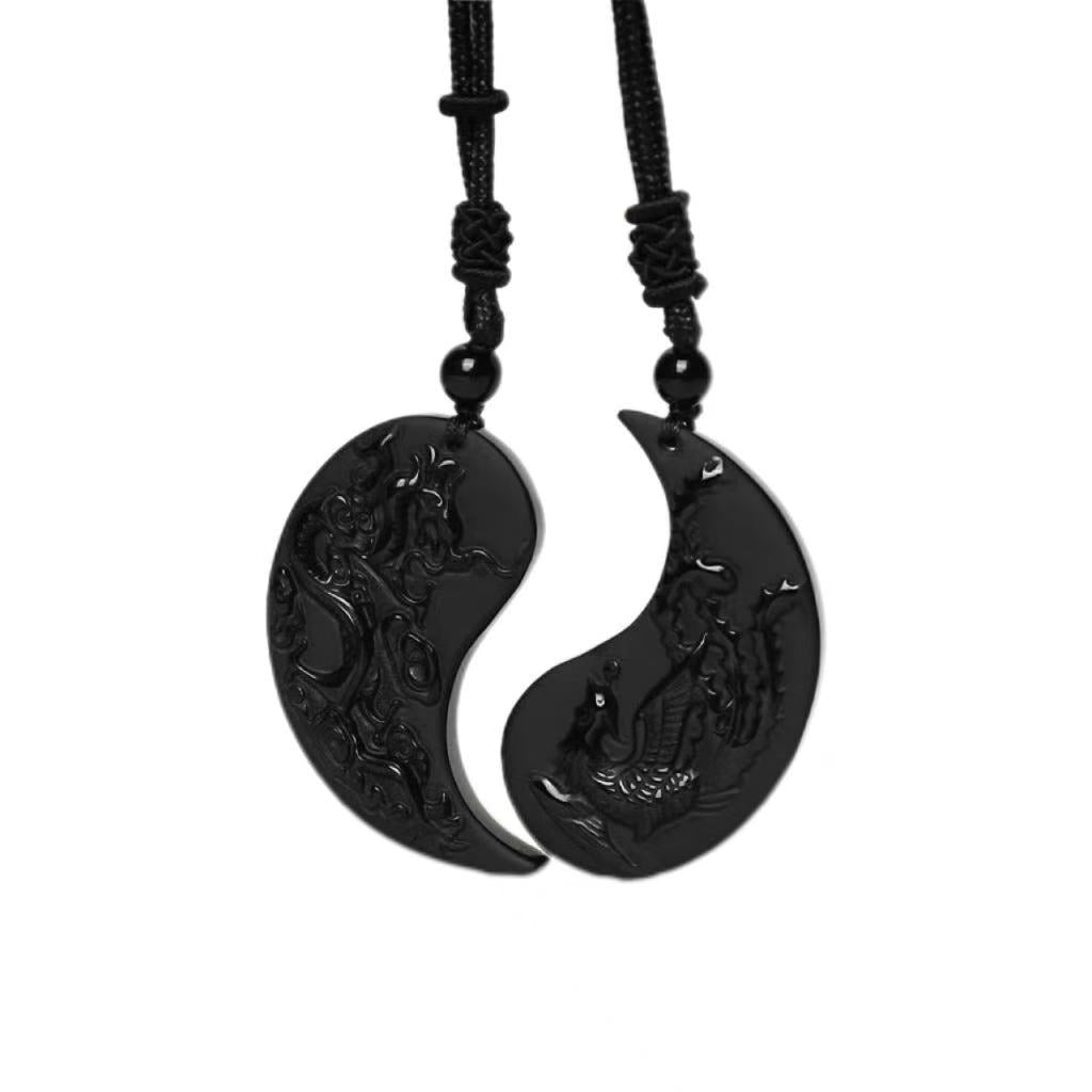 Black yin yang pendant necklace on a white background