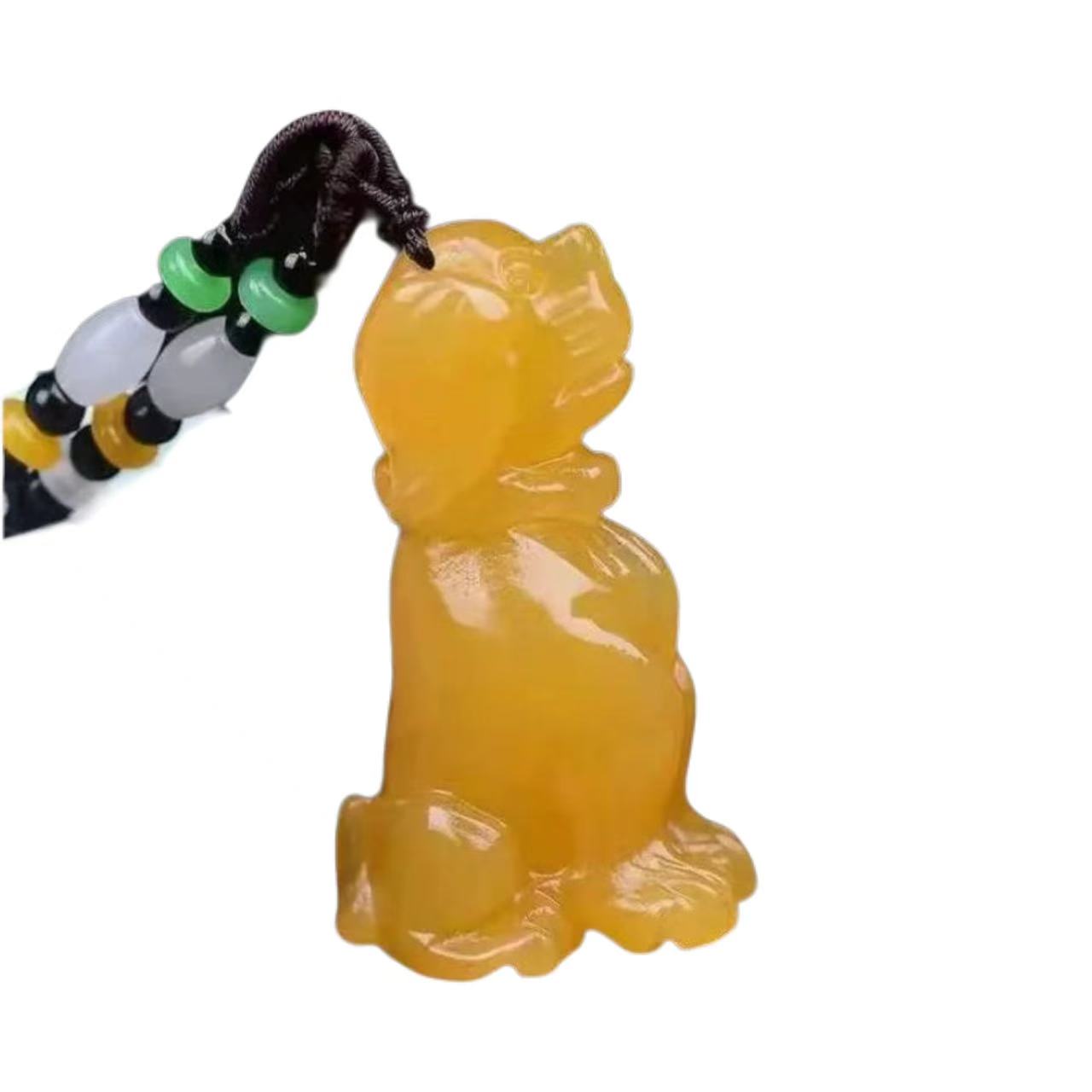 Yellow cat-shaped figurine on a black, yellow, and green beaded string against a white background