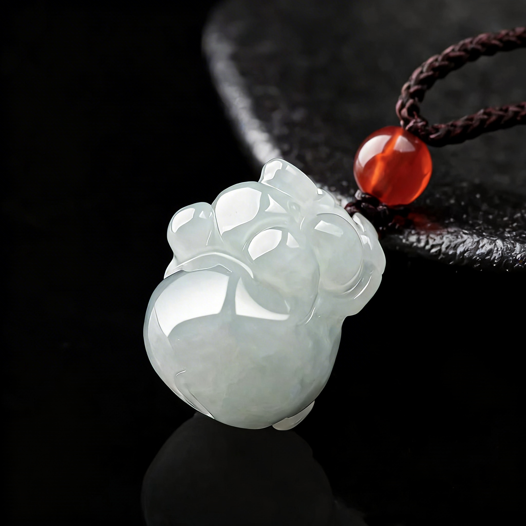Carved jade pendant on a dark background
