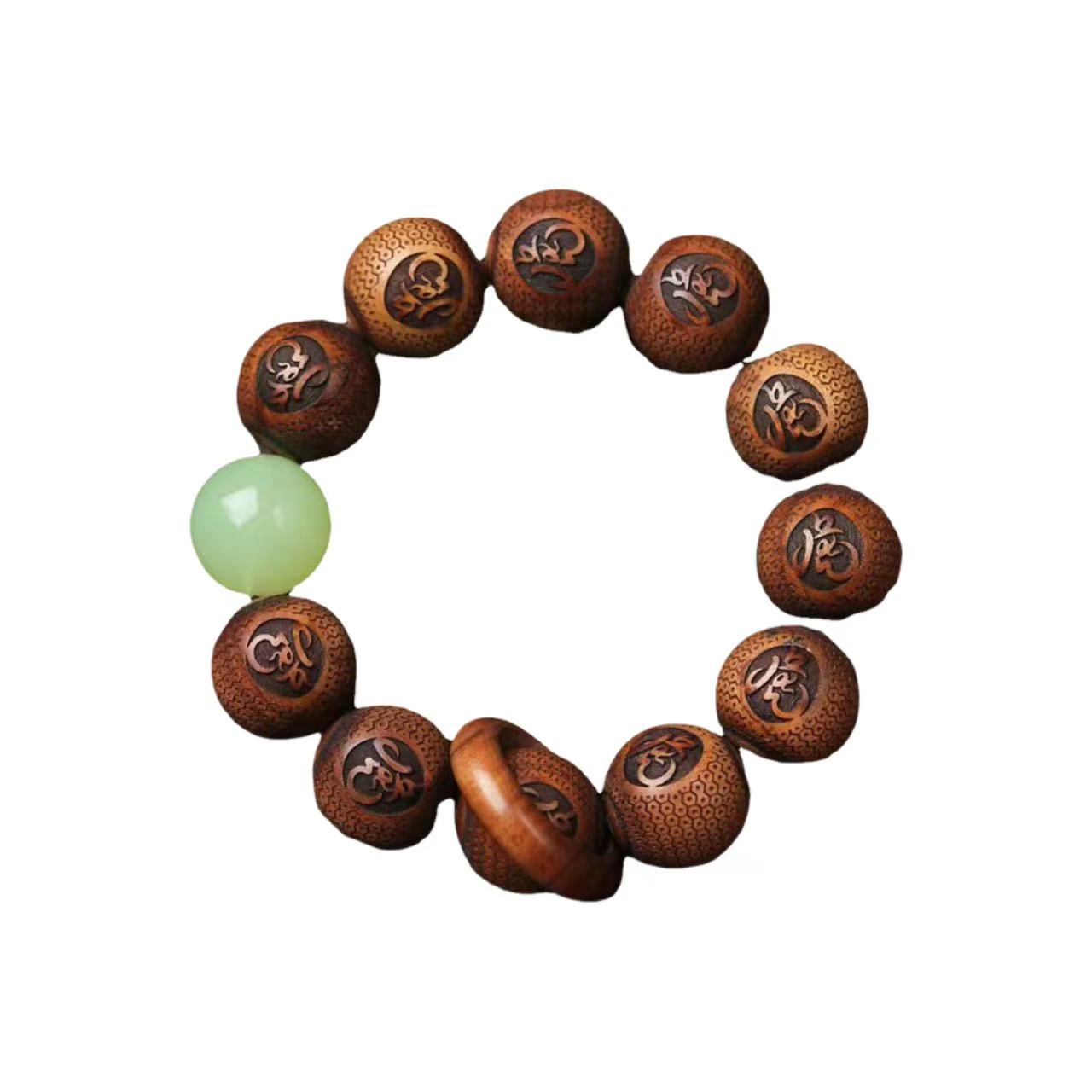 Wooden bracelet with engraved symbols and a green bead on a white background