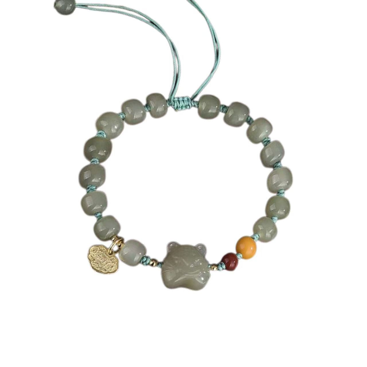 Beaded bracelet with a shell charm on a white background