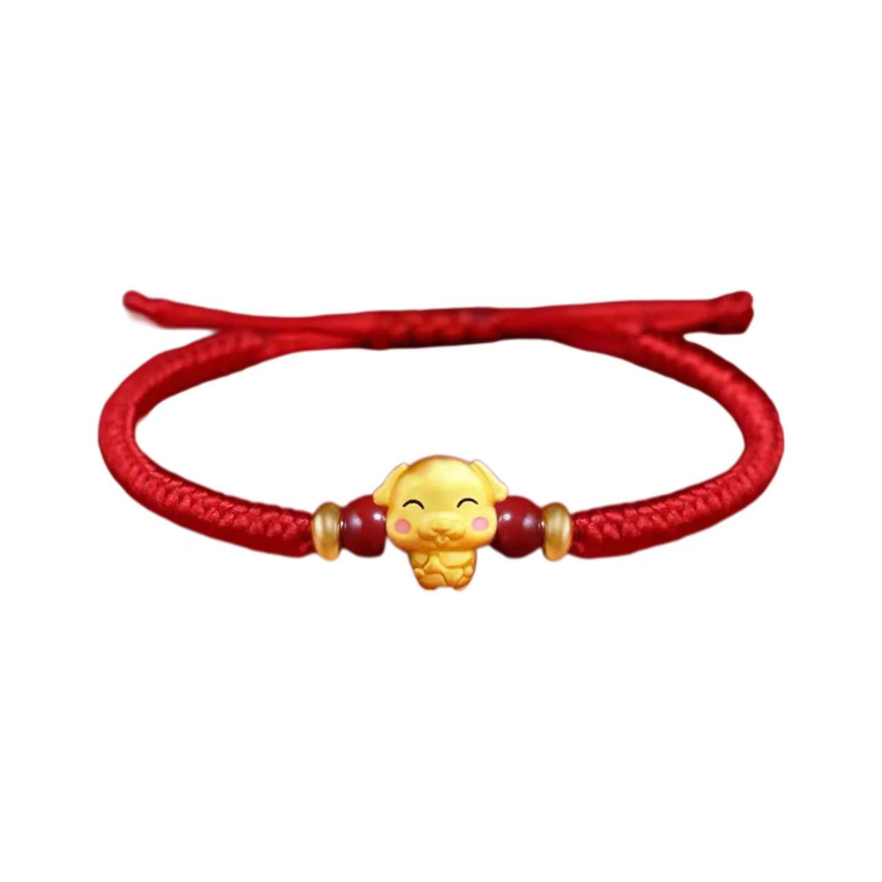 Red bracelet with a gold charm on a white background