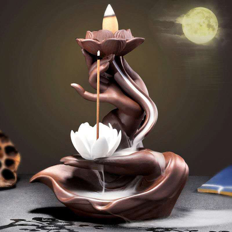 Ceramic incense burner shaped like a lotus flower with a full moon in the background.