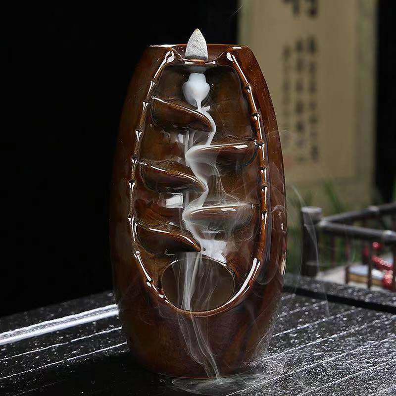 Ceramic incense burner with smoke effect on a dark surface