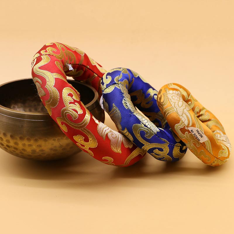 Three decorative headbands in red, blue, and yellow with gold patterns on a beige background.