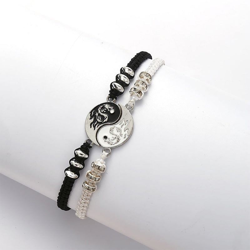 Two bracelets with a yin yang symbol on a white surface