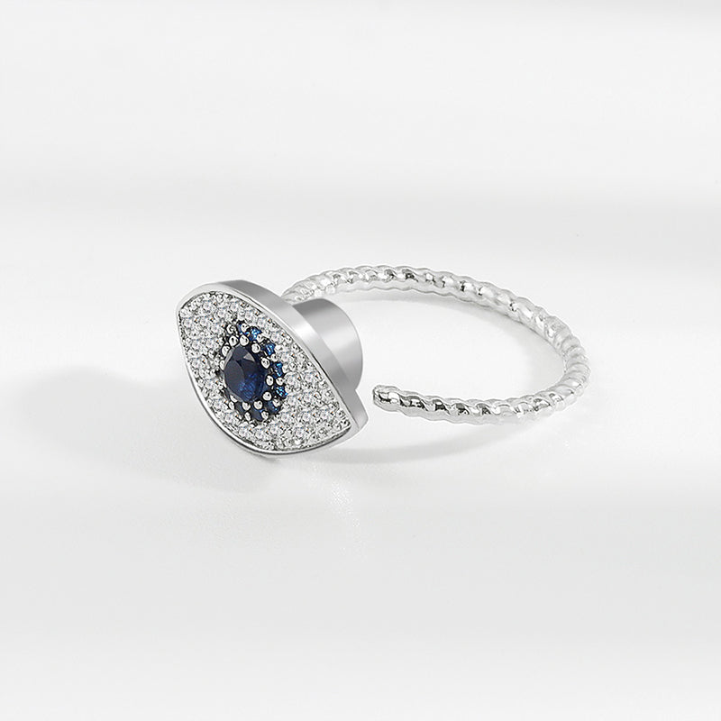 Silver ring with a blue gemstone on a white background