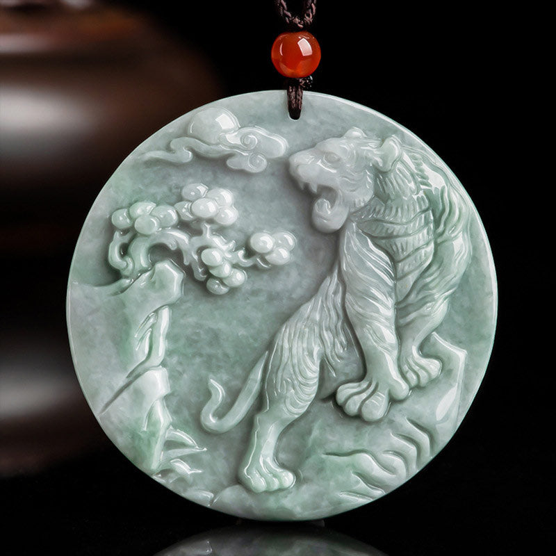 Green jade pendant with tiger design on a dark background