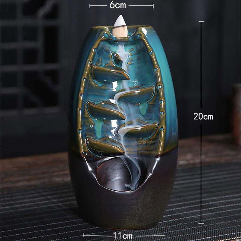 Decorative incense burner with measurements on a dark background