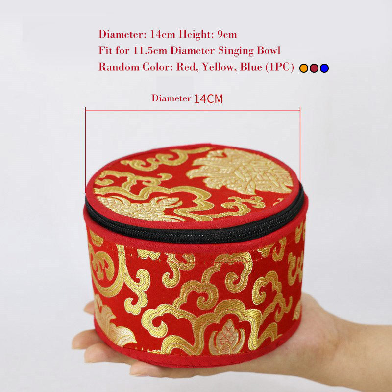Red and gold circular pouch with dragon design held by a hand, on a white background.