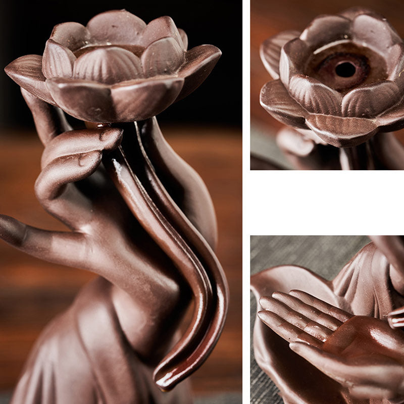 Bronze sculpture of a hand holding a lotus flower with close-up details.