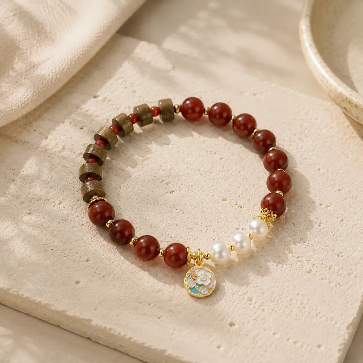 Sandalwood Pearl Agate Beaded Bracelet on textured stone surface