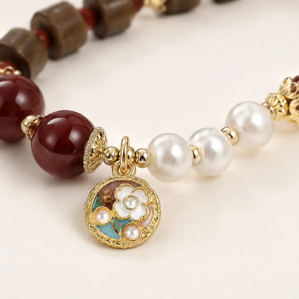 Close-up of Sandalwood Pearl Agate Beaded Bracelet with floral charm