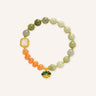 Golden Silk Jade Beaded Bracelet featuring soft green jade beads, warm orange accent beads, gold-tone spacers, and a decorative Fu charm in a clean product image.