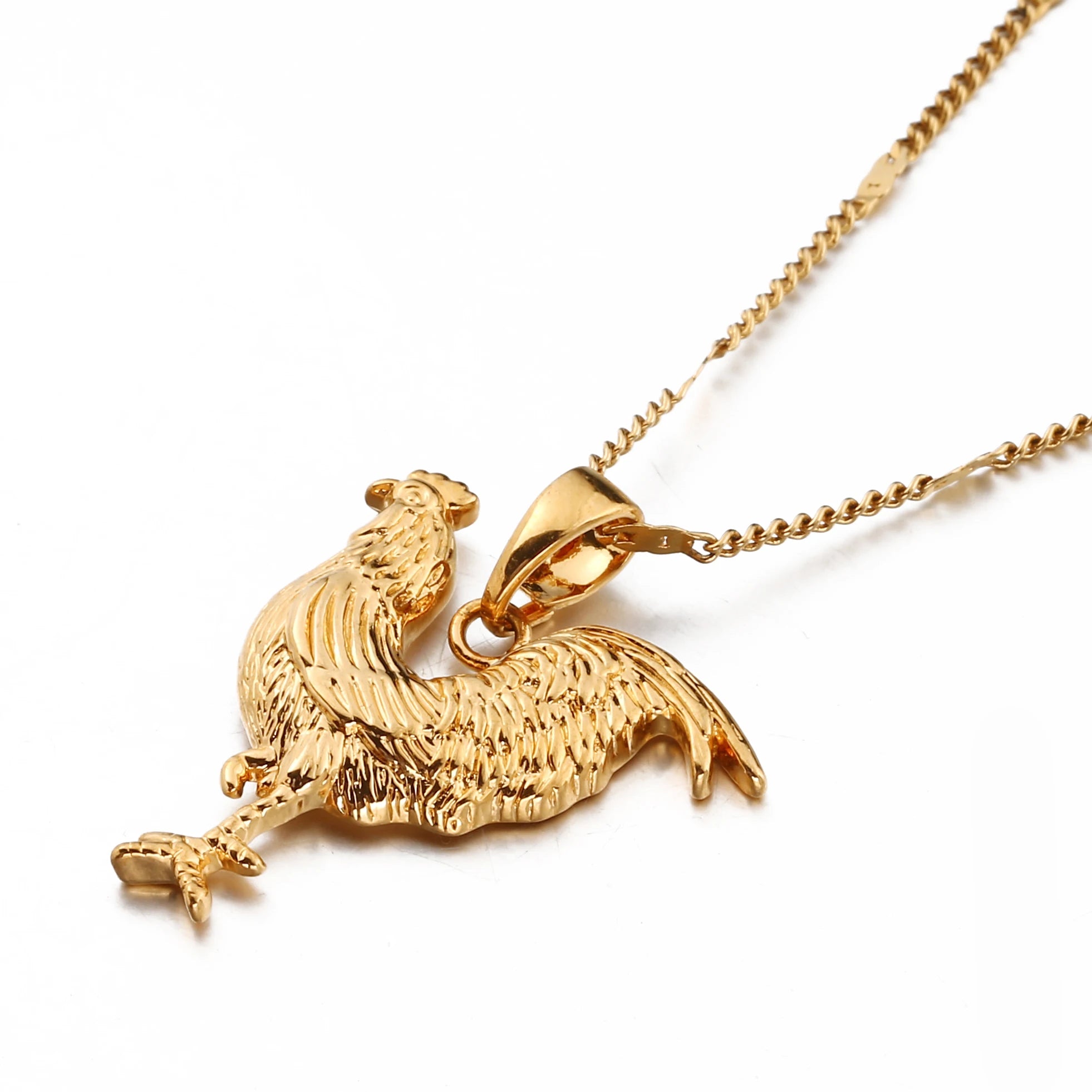 Gold rooster pendant on a chain against a white background