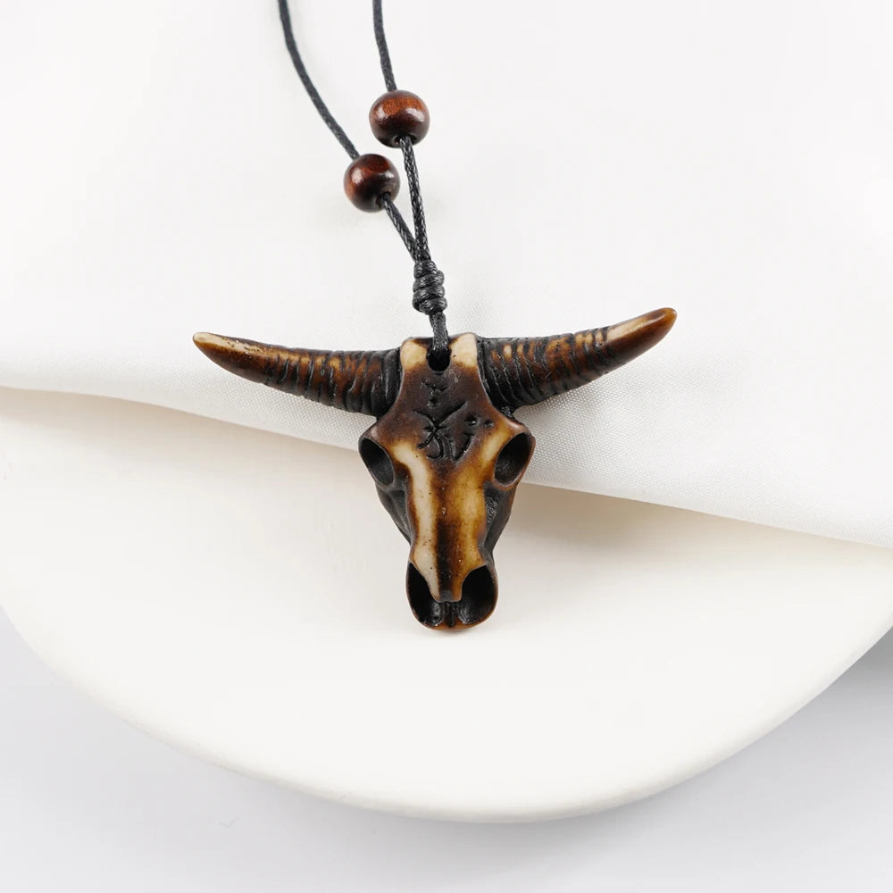 Bull skull pendant necklace on a white background