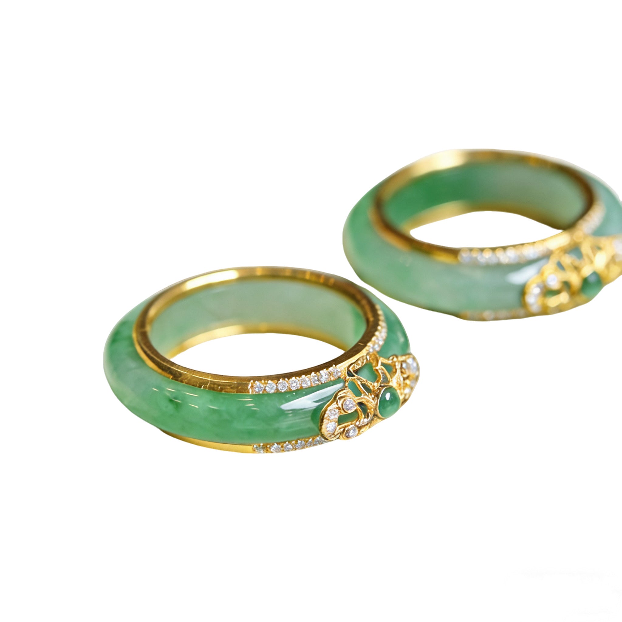 Two green bangles with gold accents on a white background