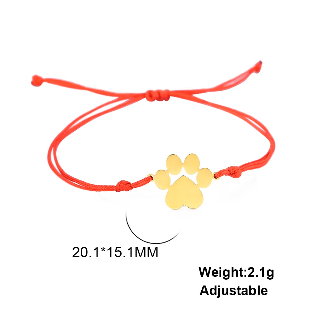 Red bracelet with a gold paw charm on a white background