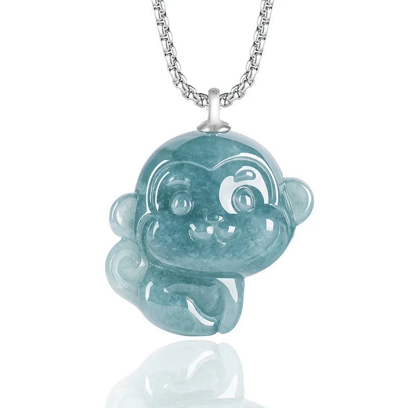 Teal monkey pendant on a silver chain against a white background