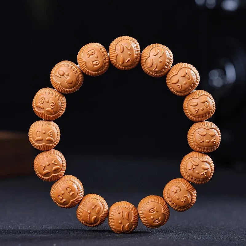 Brown beaded bracelet with embossed designs on a dark background
