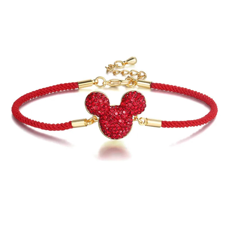 Red bracelet with a gold Mickey Mouse head charm on a white background