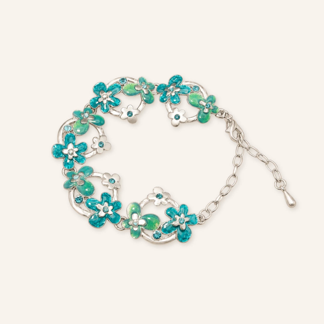 Vintage Green Flower Bracelet featuring silver-tone vine links, turquoise and green enamel flower details, blue crystal accents, and an adjustable chain closure in a clean product image.