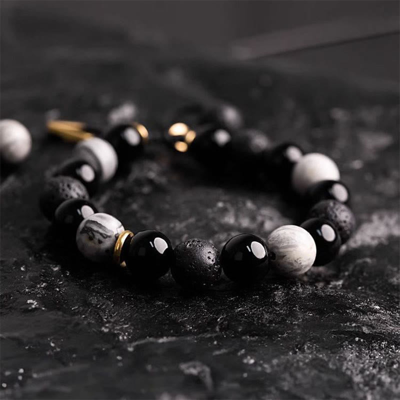 Black and white beaded bracelet on a dark textured surface