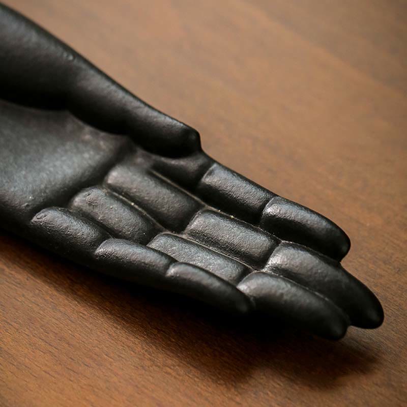 Black cast iron hand on a wooden surface