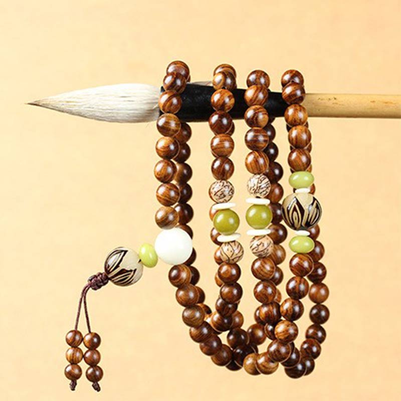 Wooden beaded bracelet with green and white accents on a beige background