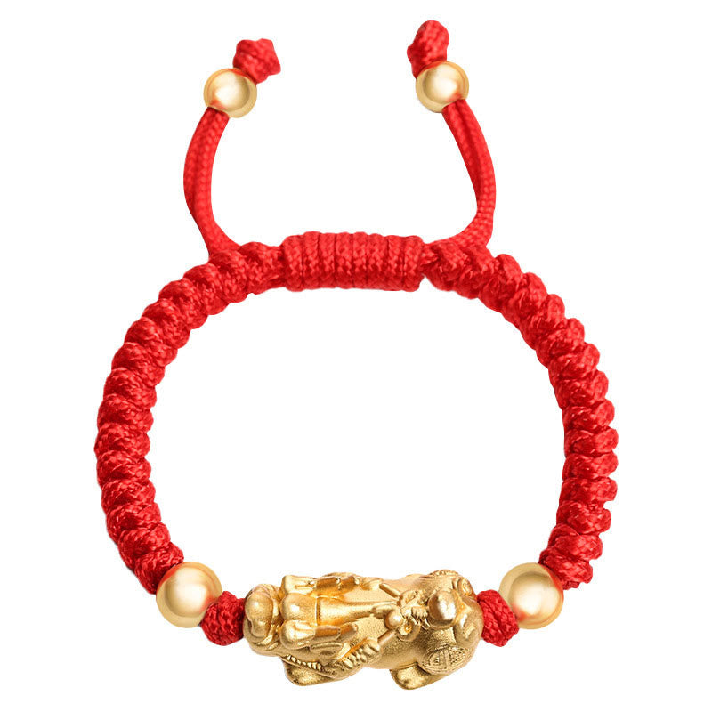 Red bracelet with gold beads and a gold lion charm on a white background