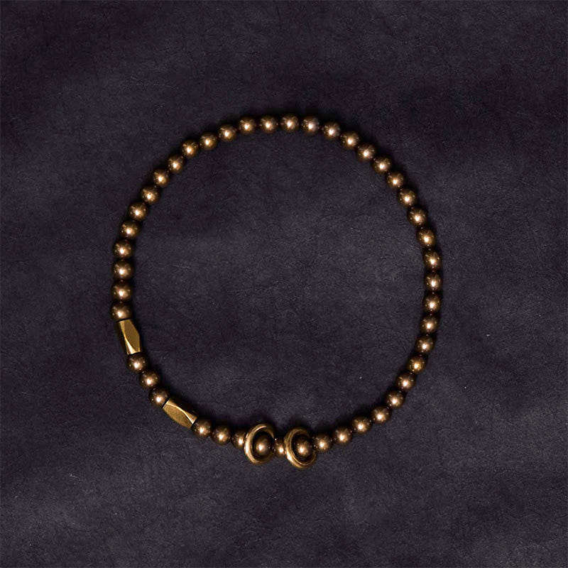 Minimalist brass and copper bead bracelet on black background – TheFuMaster