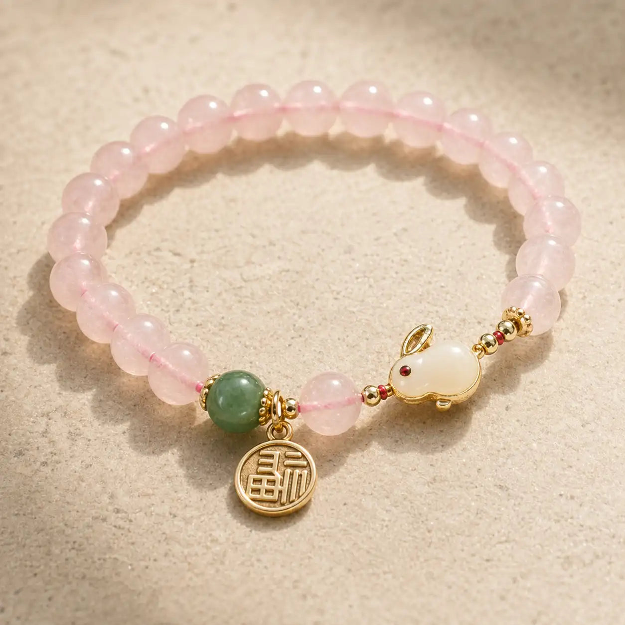 Detail view of Sacred Pink Crystal and Green Agate Bunny Bracelet with rabbit charm and gold coin charm