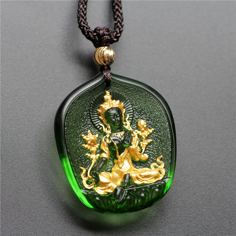 Green and gold pendant on a gray background